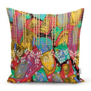 May include: A colourful throw pillow with a geometric pattern featuring gold chains, red, blue, green, and yellow colours. The pillow has a unique and modern design.