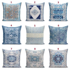 May include: A collection of nine square throw pillows featuring various blue, white, and beige patterns. Each pillow displays distinct geometric, floral, or distressed designs, numbered one through nine, arranged in a three-by-three grid layout.