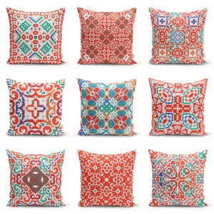 May include: Nine decorative throw pillows with vibrant, geometric patterns in red, white, blue, and green. The designs vary, featuring floral and abstract motifs. These square pillows add a pop of color and style to any living space.