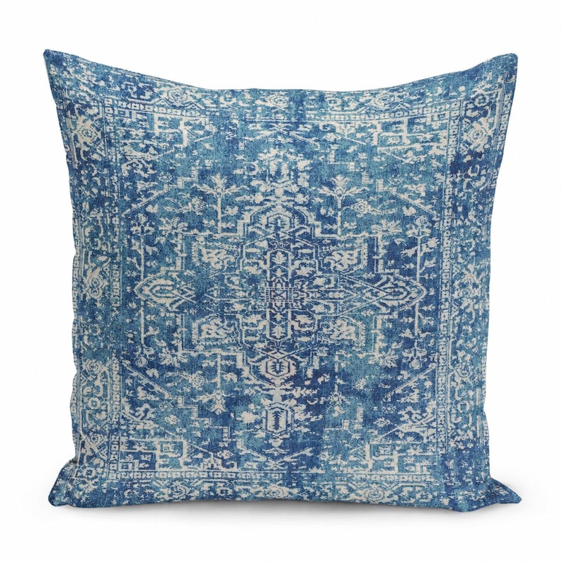 May include: A square throw pillow featuring a deep blue and off-white intricate medallion pattern. The design displays a symmetrical, detailed geometric motif with a distressed, faded appearance across the entire fabric surface.