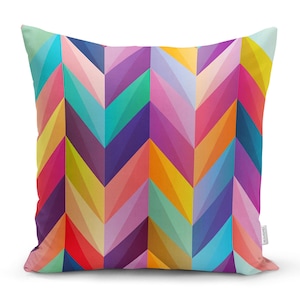 May include: A colourful throw pillow with a chevron pattern in shades of pink, purple, blue, green, yellow, and orange.