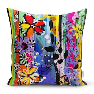 May include: A colourful throw pillow with a floral pattern and abstract brushstrokes. The pillow features a variety of colours, including red, yellow, blue, green, and purple.