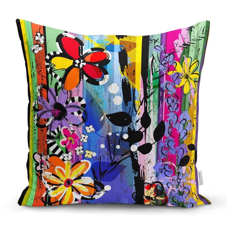May include: A colourful throw pillow with a floral pattern and abstract brushstrokes. The pillow features a variety of colours, including red, yellow, blue, green, and purple.