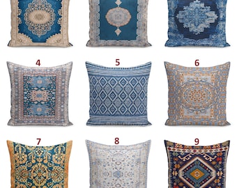 May include: A collection of nine square throw pillows featuring diverse blue, beige, and multi-colored patterns inspired by traditional rug designs. Each pillow displays intricate geometric, floral, or medallion motifs printed on the fabric surface.