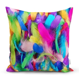 May include: A colourful pillow cover featuring a close-up of a variety of feathers in shades of pink, blue, green, yellow, and purple.