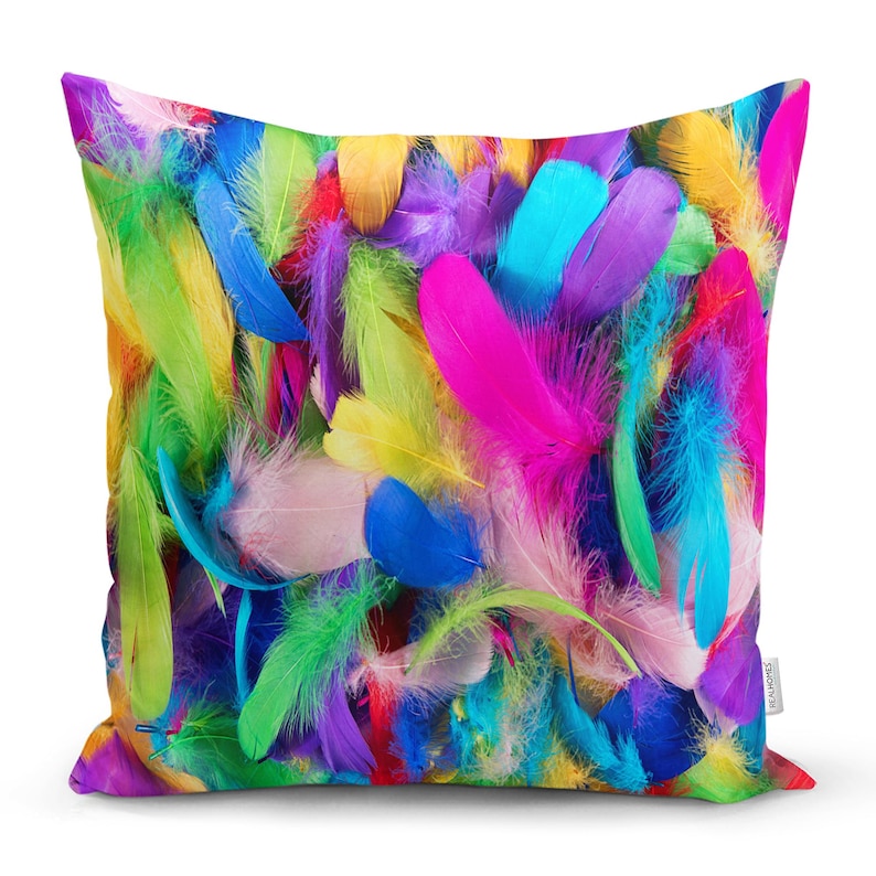 May include: A colourful pillow cover featuring a close-up of a variety of feathers in shades of pink, blue, green, yellow, and purple.