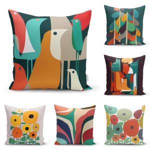 May include: A collection of decorative throw pillows with colorful, abstract designs. The pillows feature various patterns, including stylized birds, floral arrangements, and geometric shapes in shades of teal, orange, red, and yellow. The pillows are square-shaped.