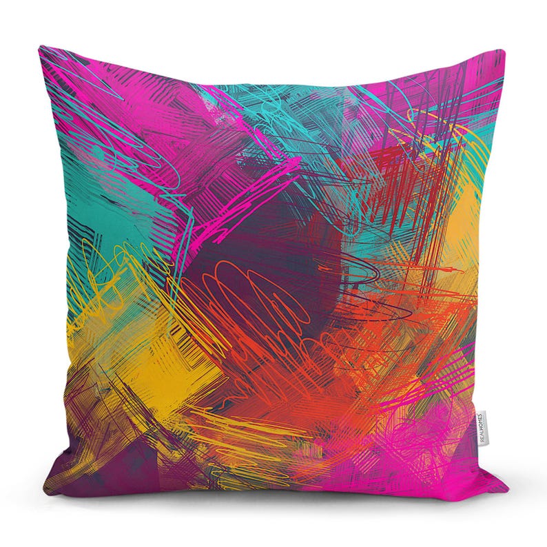 May include: A colourful throw pillow with an abstract design featuring bright yellow, pink, red, blue, and teal brushstrokes.