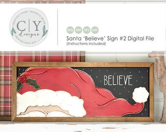 May include: A digital file for a Santa 'Believe' sign. The sign features a red Santa hat with a white trim and a black background with white snowflakes. The text 'BELIEVE' is written in white on the sign.
