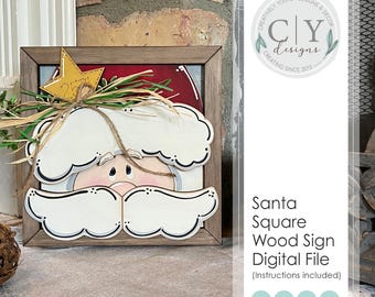 Könnte beinhalten: Ein quadratisches Holzschild mit dem Weihnachtsmann in einem braunen Rahmen. Das Schild hat einen weißen Bart und Hut, eine rosa Nase und einen goldenen Stern mit der Zahl 25. Das Schild ist mit Grün und Bindfäden verziert. Der Text "Santa Square Wood Sign Digital File" ist ebenfalls sichtbar.