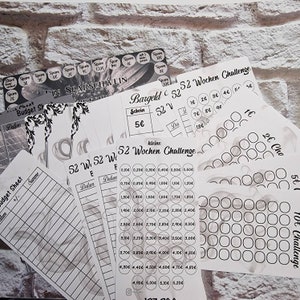 Könnte beinhalten: Ein Satz druckbarer Blätter für eine 52-Wochen-Spar-Challenge. Die Blätter sind schwarz-weiß und zeigen ein Sparschwein-Design. Die Blätter beinhalten ein Budgetblatt, einen Spar-Tracker und einen Münz-Tracker. Der Text auf den Blättern ist in deutscher Sprache.