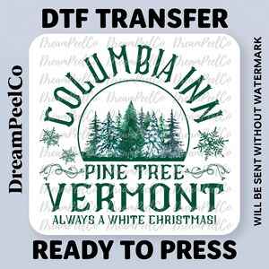 May include: A white DTF transfer with the text "COLUMBIA INN PINE TREE VERMONT ALWAYS A WHITE CHRISTMAS!" in green. The design includes a watercolor image of pine trees and snowflakes. The words "READY TO PRESS" are at the bottom.