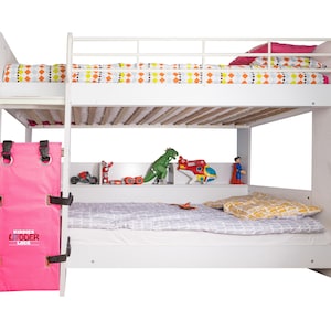 May include: White bunk bed with a pink ladder lock, a white mattress, and a white top bunk with a patterned duvet. The bottom bunk has a grey and white patterned duvet and two white pillows. There are toys on the shelf below the top bunk.