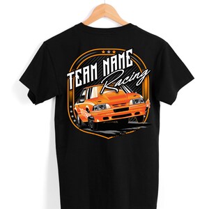May include: Black t-shirt with an orange and white graphic of a car with the text "TEAM NAME Racing" on the back.