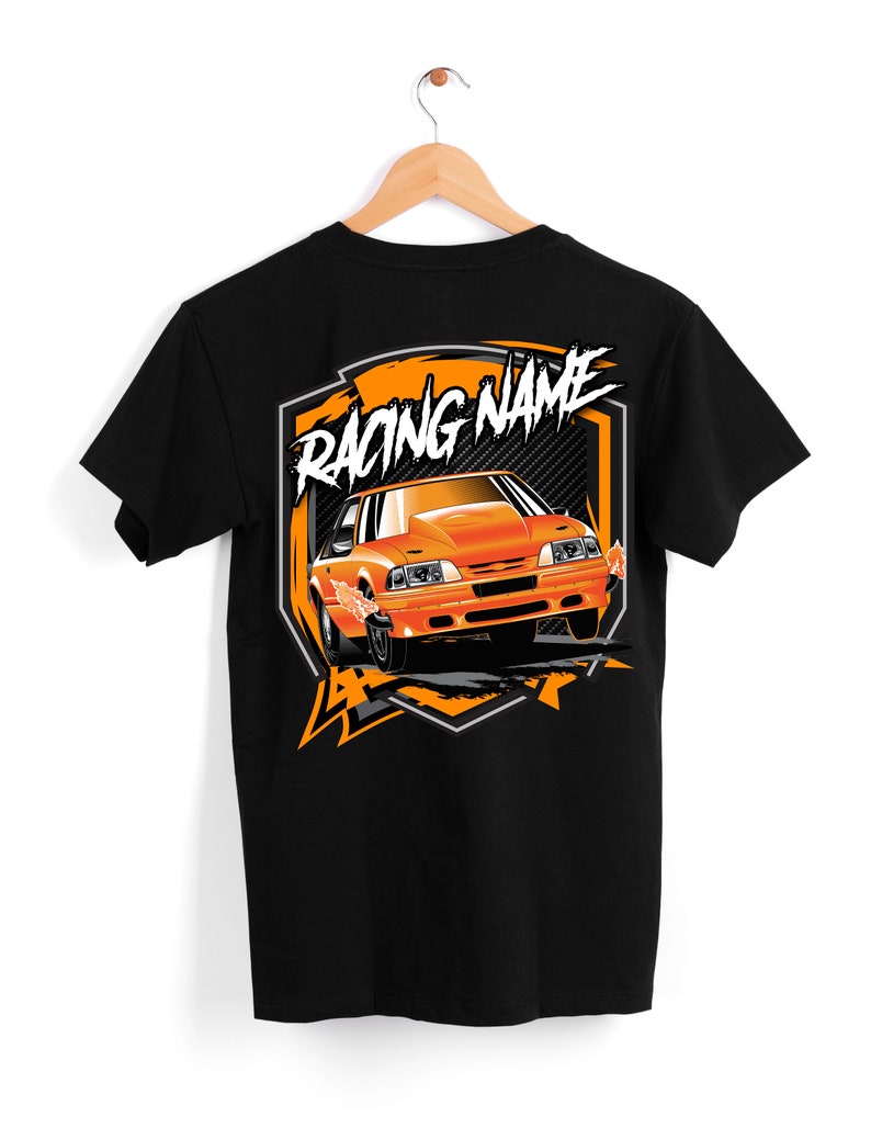 May include: Black t-shirt with an orange graphic of a car with the text "Racing Name" on a shield.