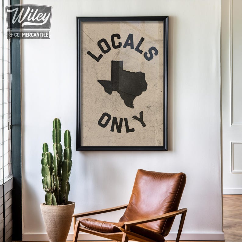 May include: A framed print with a vintage aesthetic featuring a black silhouette of the state of Texas with the text "Locals Only" in a circular design.