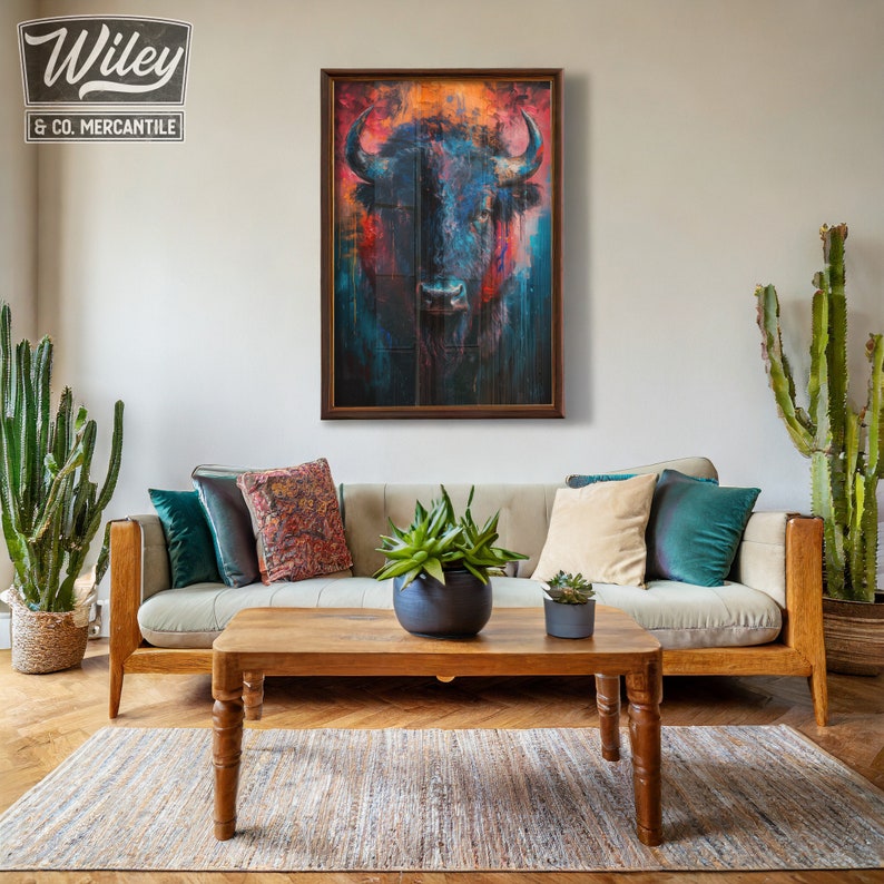May include: A framed artwork featuring a bison with a vibrant, abstract design in shades of blue, red, and orange. The artwork hangs above a beige sofa with decorative pillows. A wooden coffee table and a woven rug complete the living room setting.