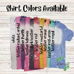 May include: A selection of t-shirts in various colors, including white, heather radiant orchid, heather purple, heather heliconia, dark heather, heather red, heather mustard, heather orange, heather irish green, and heather royal. The shirts are all tie-dyed with a white bleach design.