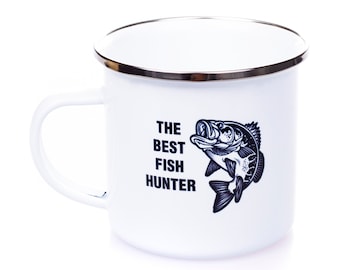 May include: White enamel mug with a black and white illustration of a fish and the text "The Best Fish Hunter".