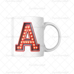 May include: White ceramic mug featuring a red letter "A" with a marquee light design. The letter is outlined in red with a blue interior and small yellow lights. The mug has a white handle.