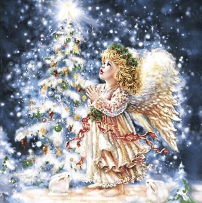 May include: A digital illustration of a blonde angel with large feathered wings, wearing a cream-colored dress with red ribbons, standing before a snow-covered Christmas tree with glowing ornaments and two white rabbits in a dark blue night scene.