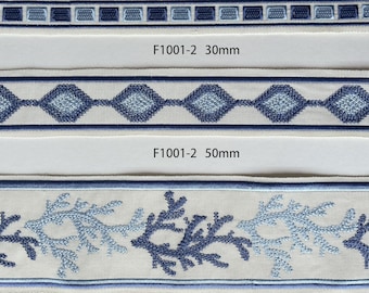 May include: Three samples of blue and white embroidered trim, showing different patterns and widths. The trim is labeled "F1001-2 30mm", "F1001-2 50mm", and "F1001-2 90mm".