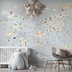 May include: A light blue world map mural with colourful illustrations of animals, landmarks, and transport. The room includes a white cot, a large stuffed toy, a chair, and a floor lamp.