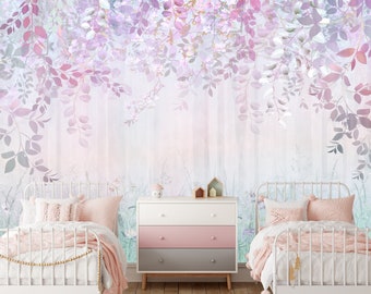 May include: Two white twin beds with pink bedding and pillows in a room with a floral wallpaper featuring a light purple and pink color scheme. A white dresser with three drawers is between the beds.
