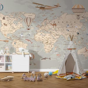 May include: A child's bedroom with a world map mural, aeroplanes, and hot air balloons. A white teepee, toy train, and soft toys are on the floor. A white cabinet with toys and books is on the left.