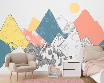 May include: A white wall with a hand-drawn mountain range mural in shades of yellow, blue, pink, and gray. The mural features a yellow sun in the upper right corner. A white nightstand with two drawers is in the lower right corner of the image. A light beige armchair is in the lower left corner of the image.