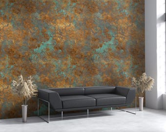 May include: A modern living room featuring a black leather sofa with metal legs, set against a textured wall with a copper and teal color scheme. Tall, slender vases with dried plants flank the sofa, and a large window provides natural light.