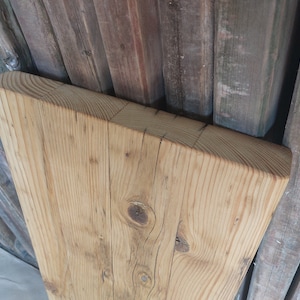 May include: A rustic wooden sign with the text "Welcome to our home" in white lettering. The sign features a distressed finish and a simple, inviting design, perfect for entryway decor.