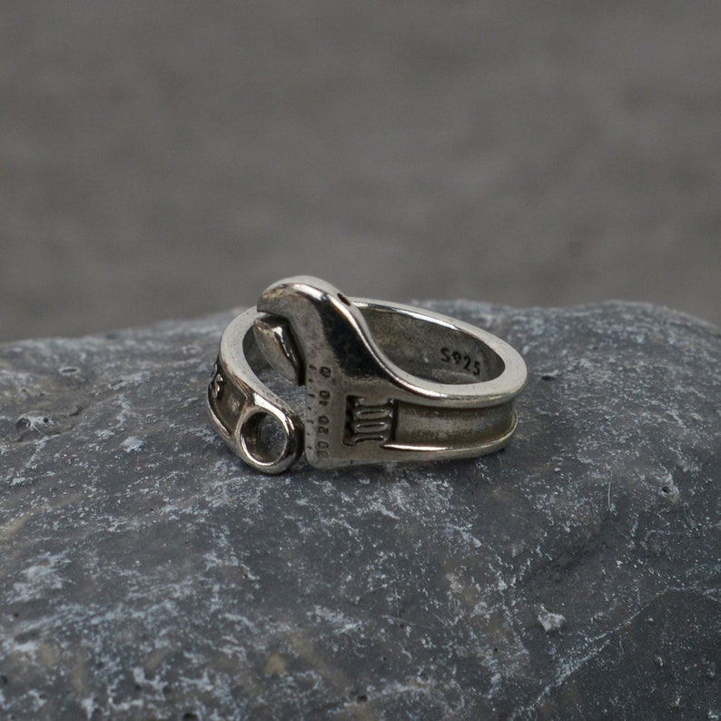 May include: Silver adjustable wrench ring with the inscription "S925" and "D80 10 11 12 13 14 15 16 17 18 19 20 21 22 23 24 25 26 27 28 29 30 31 32 33 34 35 36 37 38 39 40 41 42 43 44 45 46 47 48 49 50 51 52 53 54 55 56 57 58 59 60 61 62 63 64 65 66 67 68 69 70 71 72 73 74 75 76 77 78 79 80 81 82 83 84 85 86 87 88 89 90 91 92 93 94 95 96 97 98 99 100"