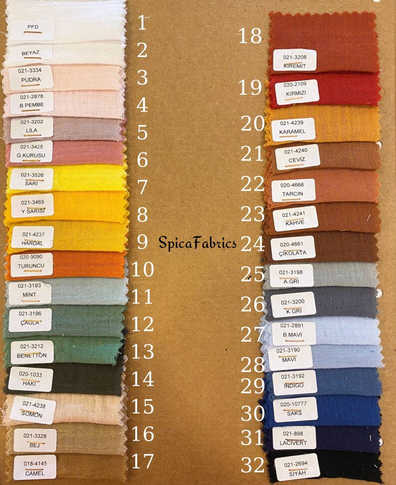 May include: A fabric swatch chart featuring 32 color samples. The swatches are arranged in rows and columns, showcasing a variety of hues, including white, pink, yellow, orange, green, blue, and brown. Each swatch has a corresponding number and color name.