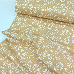 May include: Beige fabric with a white repeating pattern of stylized branches and birds.