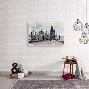May include: Watercolor painting of a cityscape with a bridge and several buildings. The buildings are a mix of gray and brown, and the bridge is gray. The sky is a light blue with some clouds.