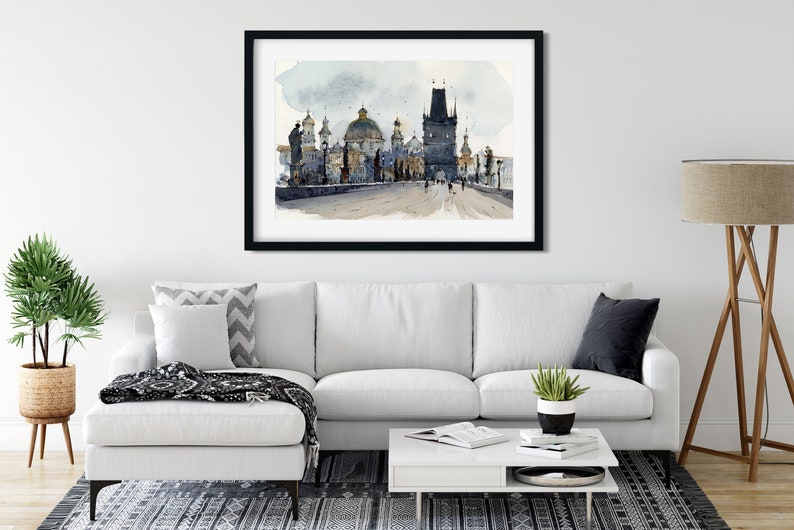 May include: A watercolor painting of a bridge in Prague, Czech Republic. The bridge is lined with buildings and towers, and there are people walking across it. The painting is done in shades of gray and blue, with hints of gold.