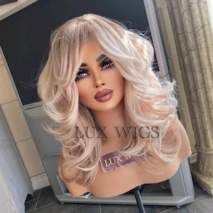 Cecilia: 80s Hairstyle! Short Blonde Wig. Curly Short Blonde Wig. Natural Blonde Wig. Blonde wig with fringe. Darker Strawberry Blonde Root.