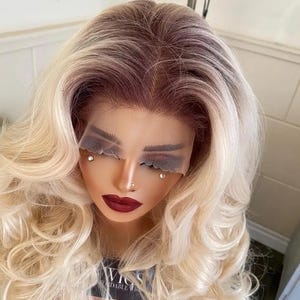 Ashley Light Blonde 13×4 Lace Front Wig – Glueless Synthetic Wig with Light Brown Roots, 28” Long Wavy, Natural Hairline, 180% Density