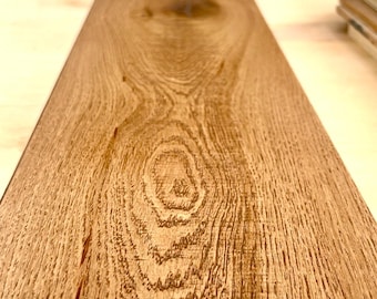 May include: Close-up of a single, light brown wood plank with a detailed grain pattern. The plank has a natural wood color with visible knots and textures. The wood appears to be part of a flooring or paneling system.