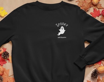 May include: Black sweatshirt with a white ghost graphic and the text "Spooky season" on the front.