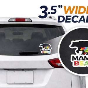 May include: A 3.5-inch wide decal featuring a black bear silhouette with a colorful puzzle piece design, and the words "MAMA BEAR" in a rainbow color scheme. The decal is shown on a car window.