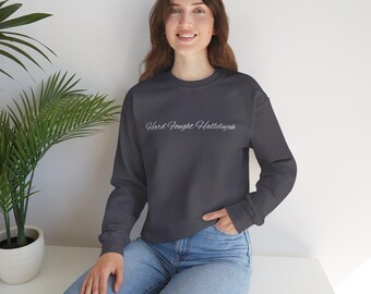 May include: A dark gray sweatshirt with the text "Hard Fought Hallelujah" in white cursive lettering.