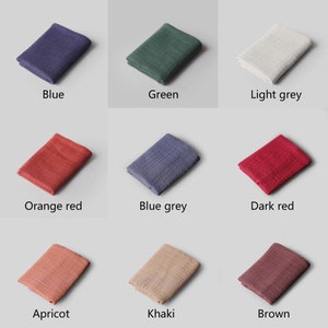 May include: Nine fabric swatches in various colors, including blue, green, light grey, orange red, blue grey, dark red, apricot, khaki, and brown. The swatches are arranged in a grid pattern on a light grey background.