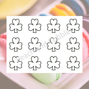 May include: A sheet of printable stickers featuring 12 shamrock designs. Each shamrock is outlined in black and ready to be colored.