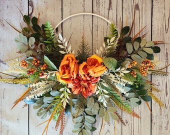 Rustic country hoop wreath with cream and green ferns and burnt orange flowers