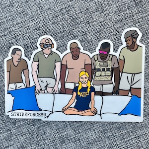 May include: A sticker featuring a group of six people sitting on a white couch. The people are wearing casual clothing and have different skin tones. The woman in the center is wearing a blue shirt with the letters "ATP" on it. The sticker has the text "STRIKEFORCE69" on the bottom.