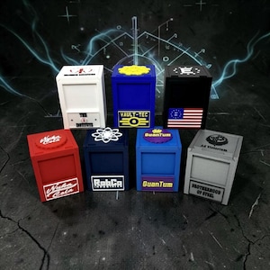 May include: Seven colorful, rectangular boxes with various logos and text. The boxes are red, white, blue, black, and gray. The text includes "Nuka Cola", "Vault-Tec", "The Institute", "RabCa", "Quantum", "Brotherhood of Steel", and "Ad Victorium".