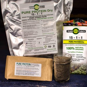 May include: A close-up of three bags of organic fertilizer labeled "Pure Protein Dry 15-1-1". The bags are labeled as 100% natural and organic. The Cadillac of Fertilizers.  The bags are on a blue wooden surface.