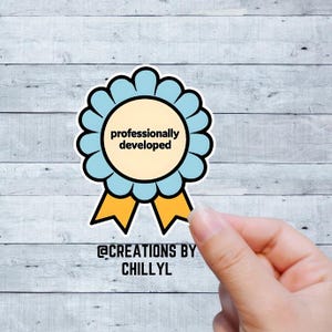 May include: A sticker featuring a light blue and gold rosette design with the text "professionally developed" in black. The sticker has a scalloped edge and two gold ribbons. The text "@CREATIONS BY CHILLYL" is at the bottom.